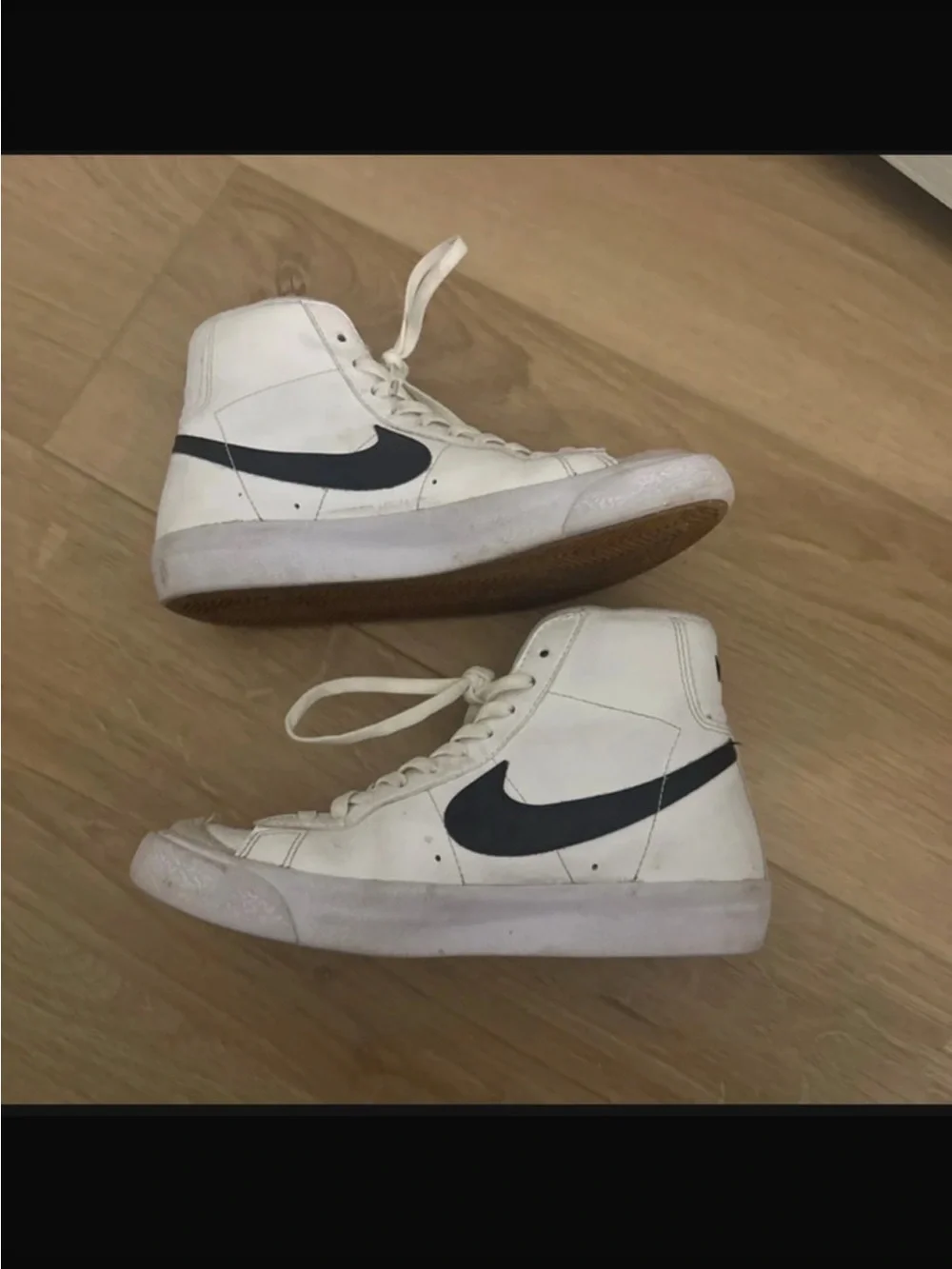 Nike White High-Top Sneakers with Black Swoosh